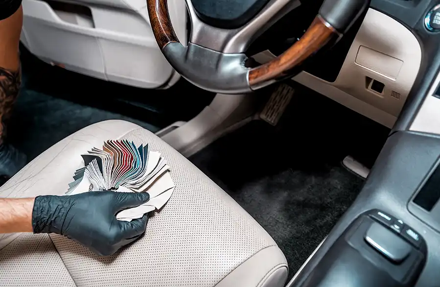 Phoenix auto upholstery craftsman helping a customer choose interior materials at a family-owned shop.