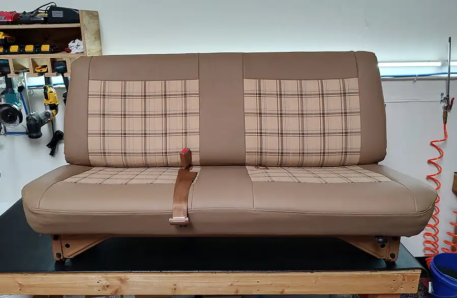 Finished bench seat upholstery after foam rebuilding on the workbench